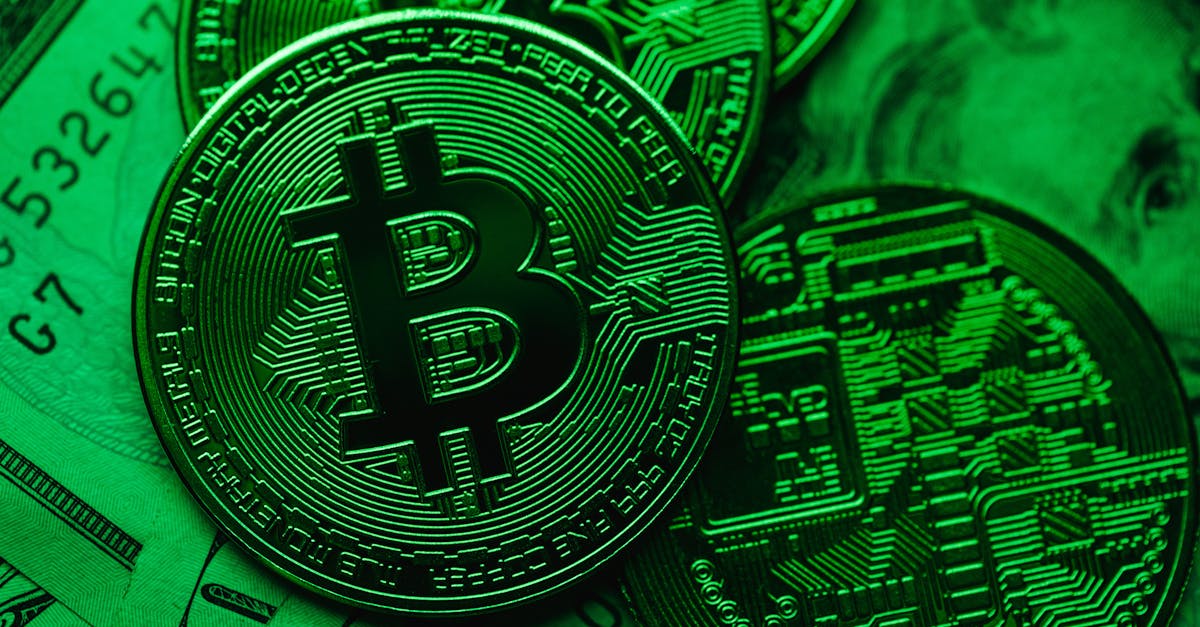 Close-up of Bitcoin coins on paper cash, with a green color tint.