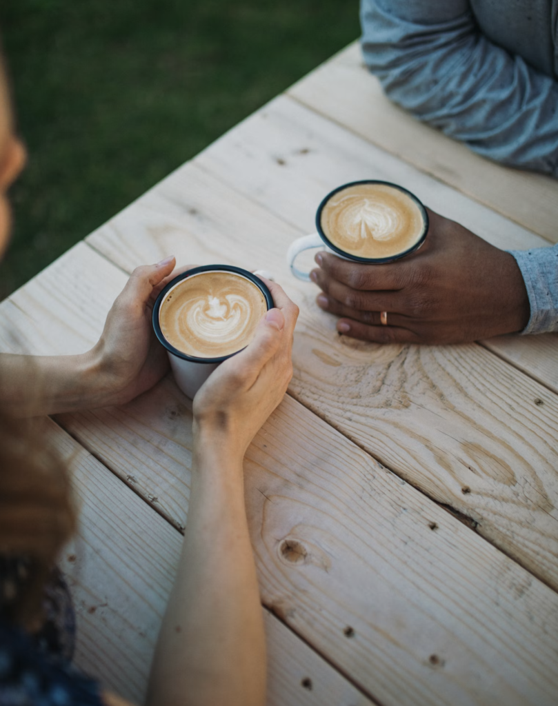 Two cups of coffee on a cafe table representing a typical first date meeting